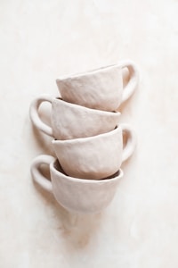 white ceramic mug on white table