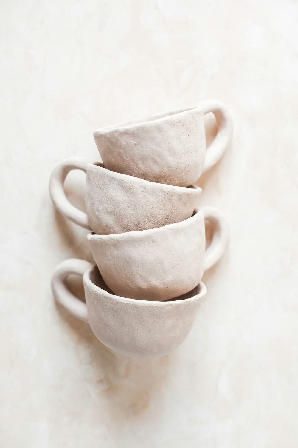 white ceramic mug on white table