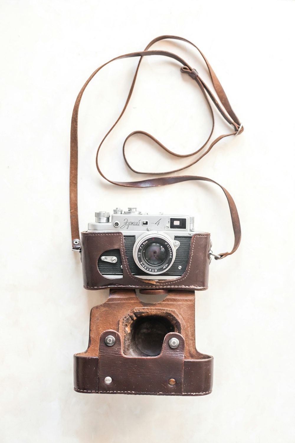 brown and black camera on white surface