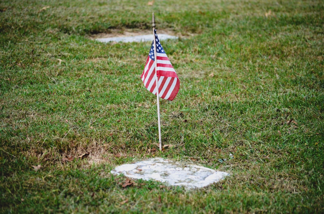 us a flag on gray concrete, American flag on military grave marker