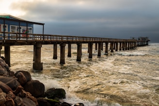 black wooden bridge over the sea