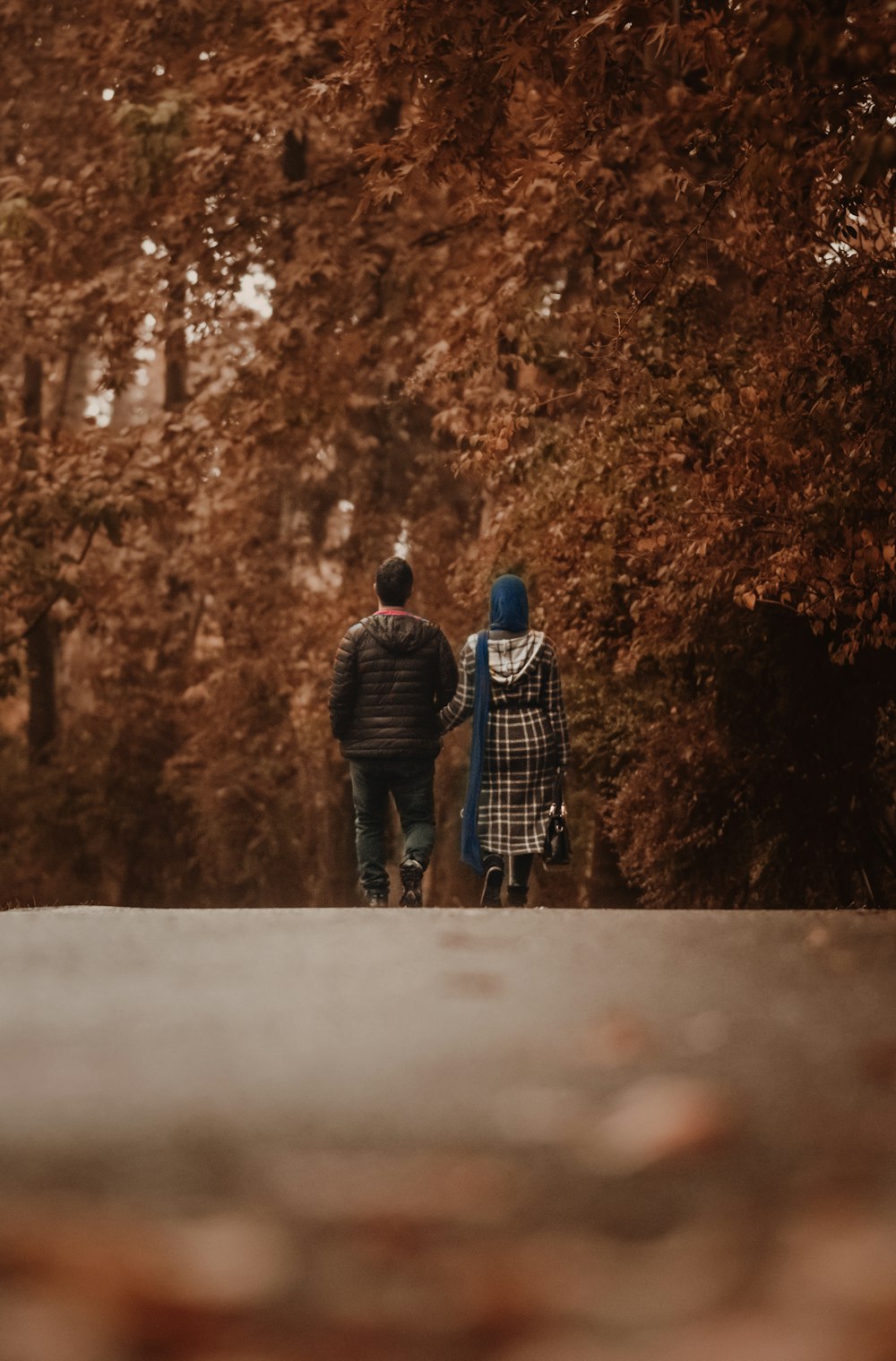 man and woman walking on road during daytime