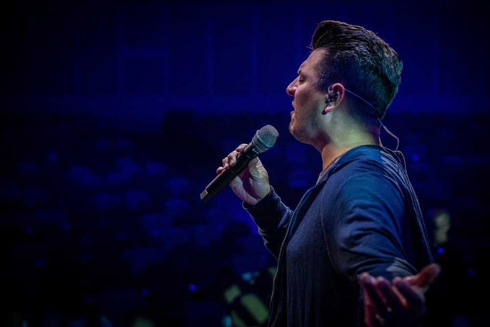 man in black suit singing