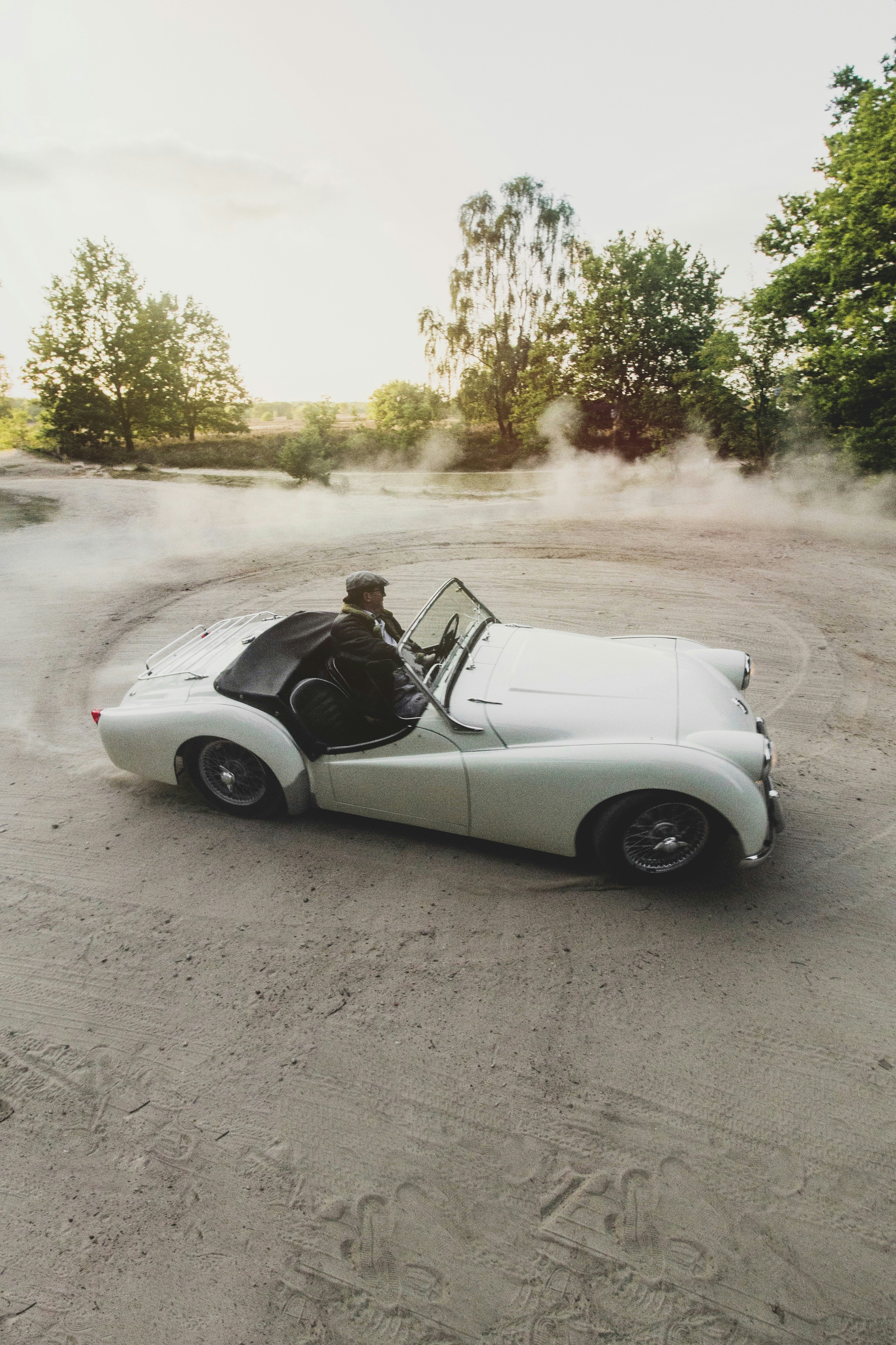 white convertible car on road during daytime