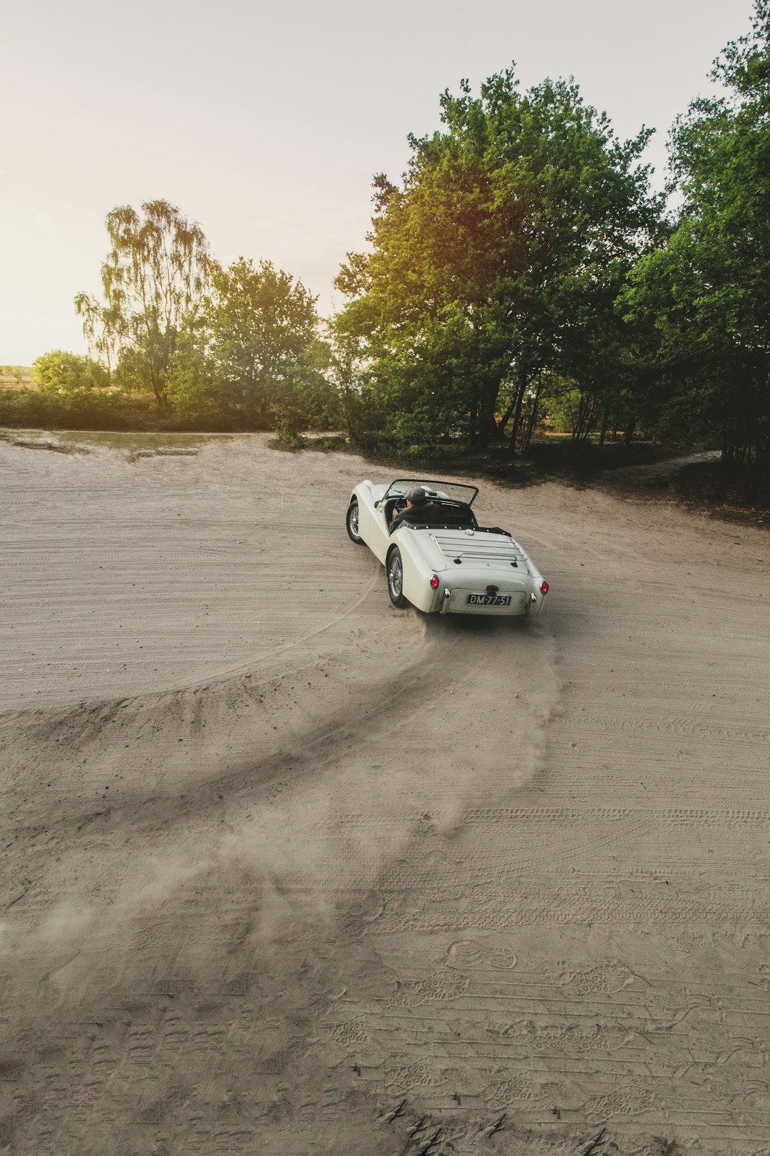 white coupe on gray road during daytime