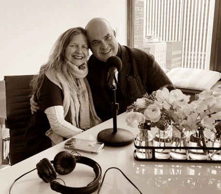 A smiling couple reviewing their financial plan with a Texas Rose Benefits advisor in a bright office.