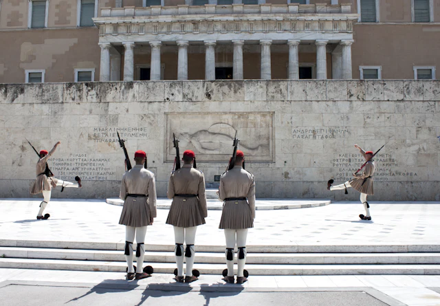 Evzones presidential guards perform the changing of the guard in front of the Greek Parliament in Syntagma Square.