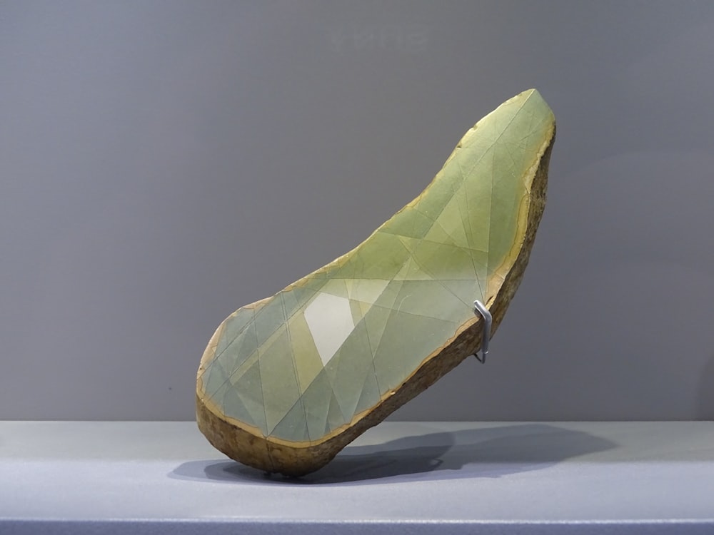 green and white leaf on white surface