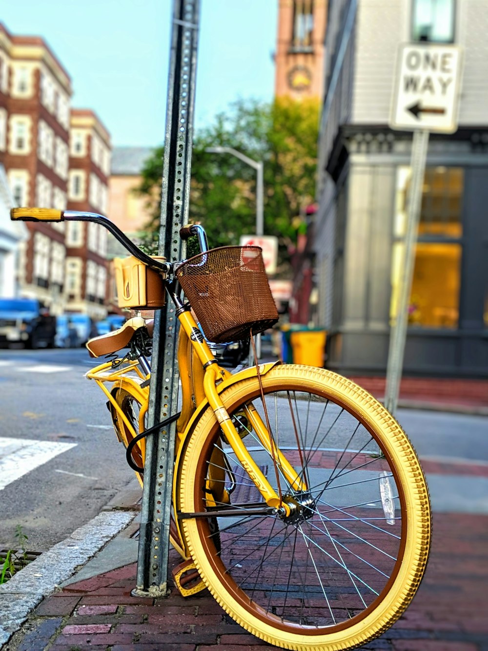 yellow city bike parked on sidewalk during daytime