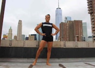 Stylish anime character posing confidently with a futuristic cityscape in the background.