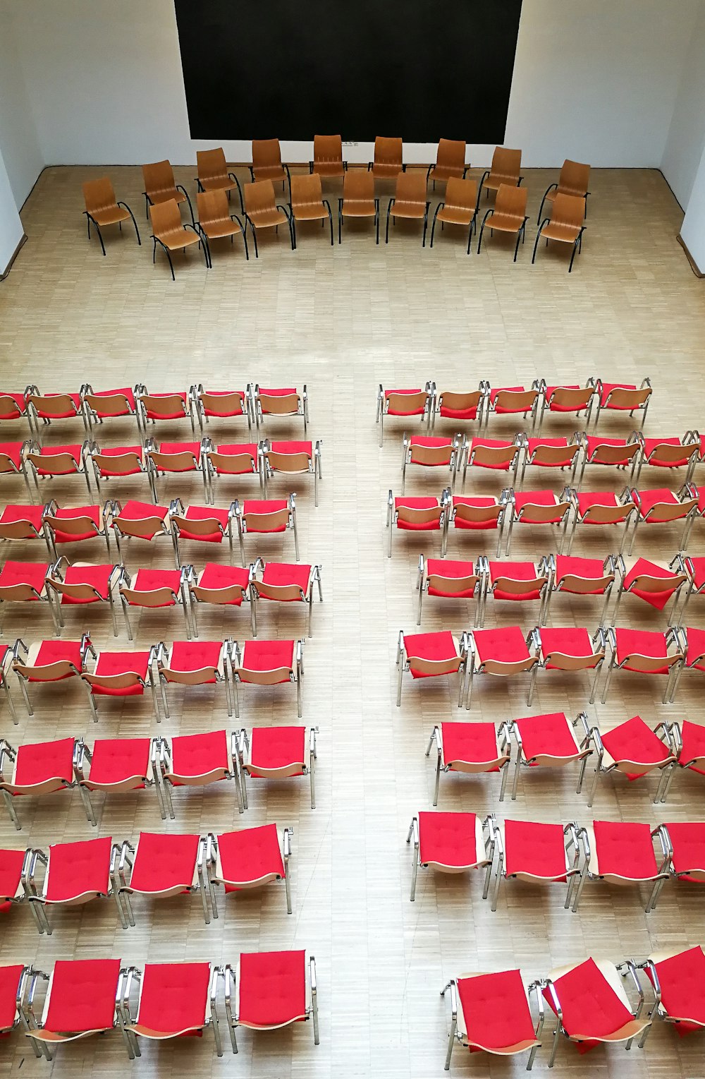 red and white plastic chairs on brown wooden floor