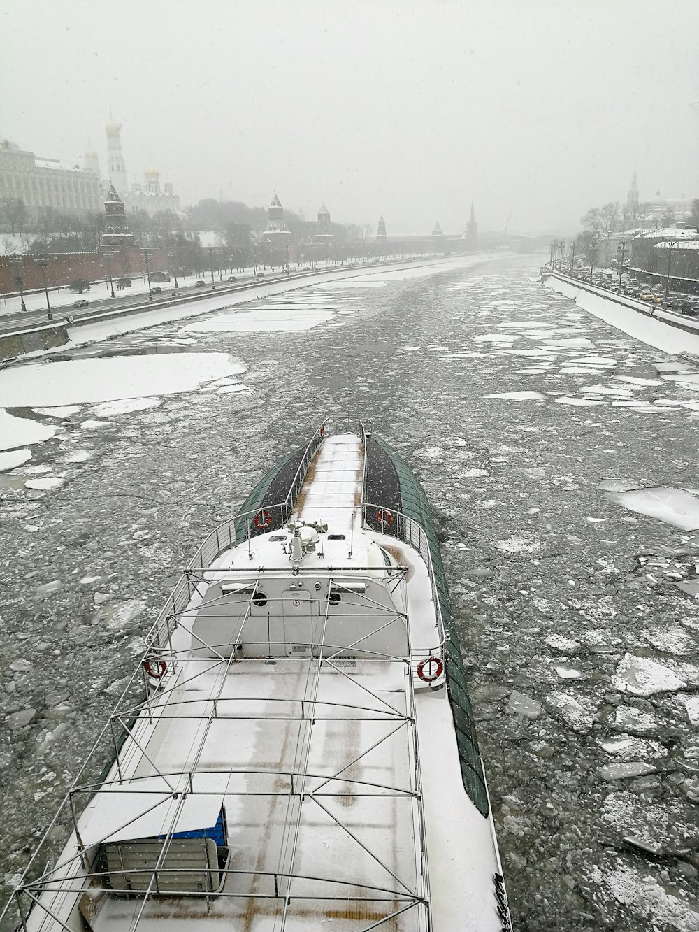 white and green boat on water