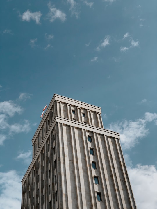 brown concrete building under blue sky during daytime in Hotel Warszawa Poland