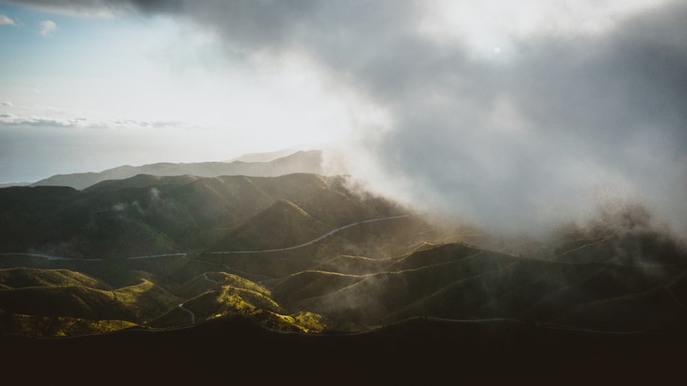 green mountains under white clouds during daytime