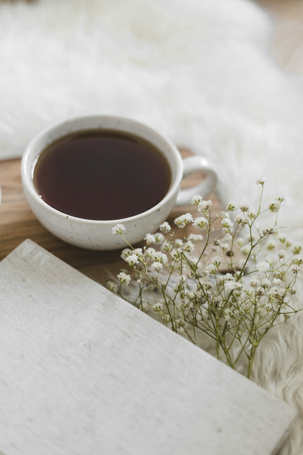 white ceramic mug with brown liquid