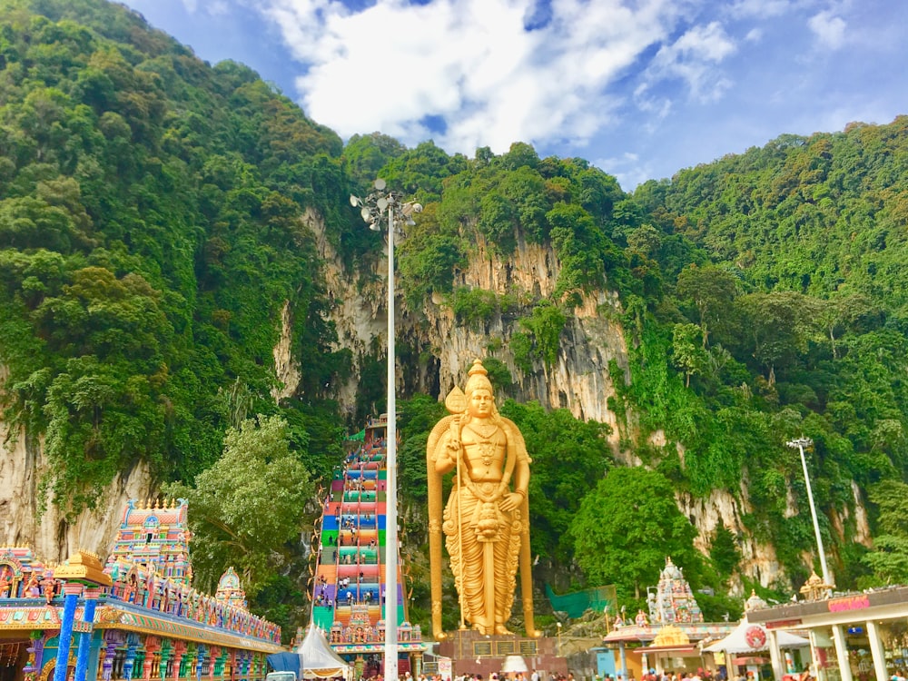 gold statue on mountain during daytime