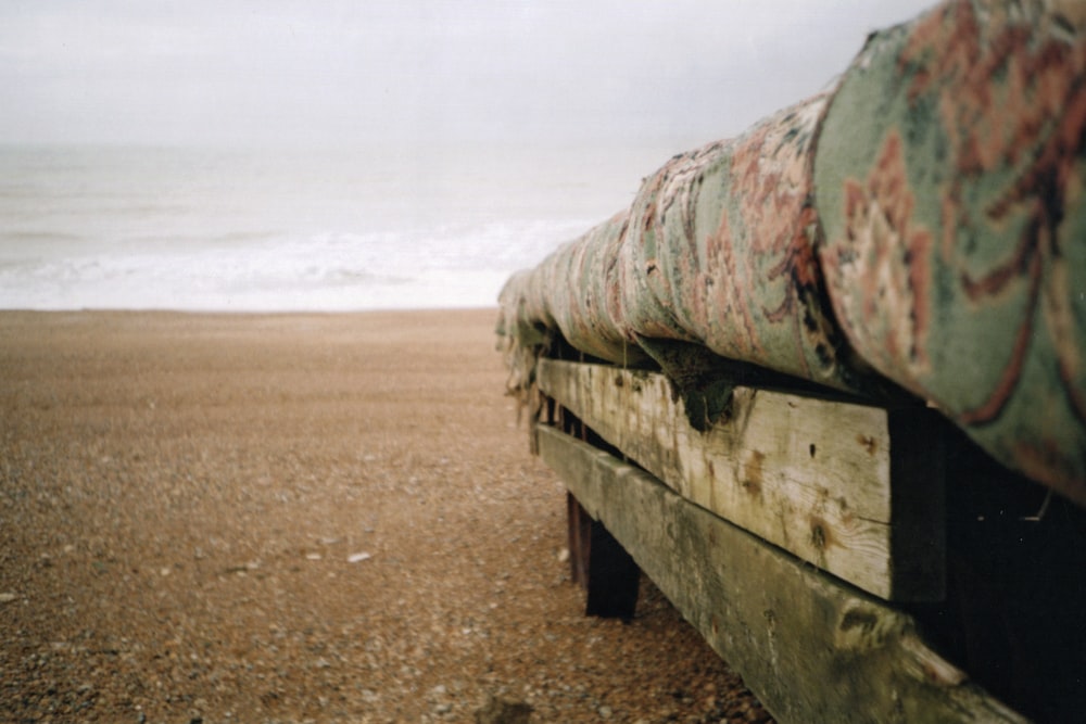 green and brown metal tank on brown sand during daytime