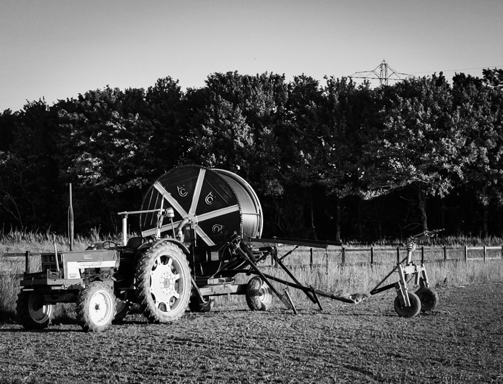 grayscale photo of tractor on field