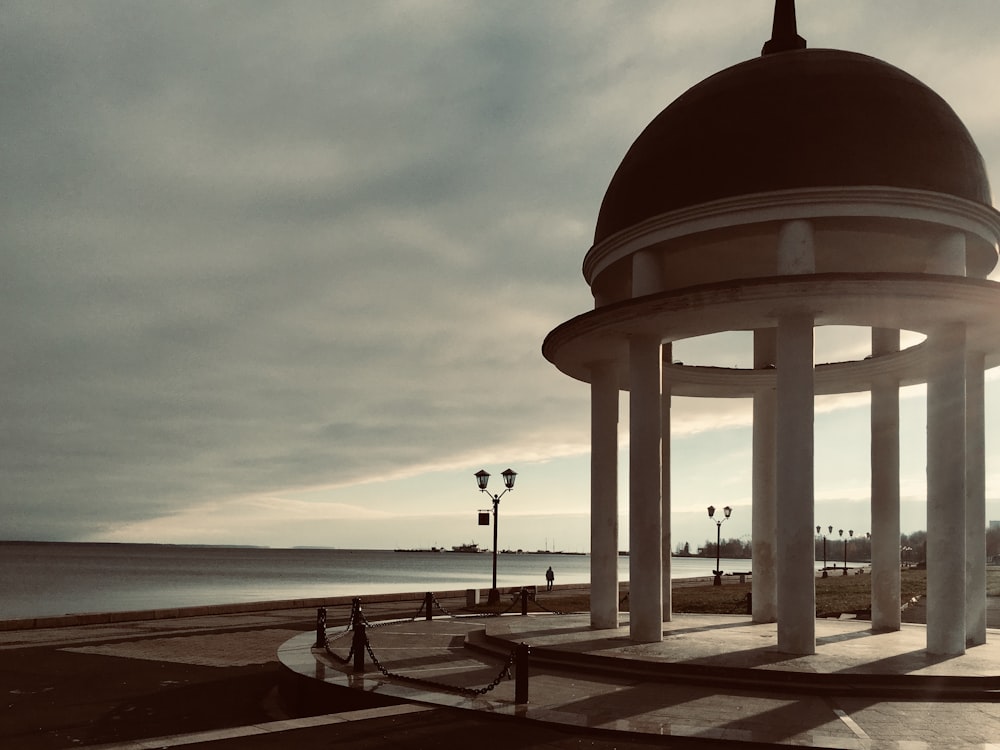 white and red dome building near body of water during daytime