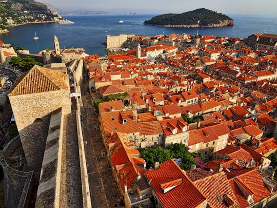 aerial view of city buildings near body of water during daytime in Muralles de Dubrovnik Croatia