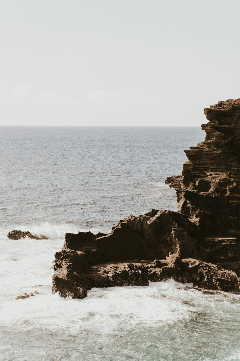 Formation rocheuse brune sur la mer pendant la journée