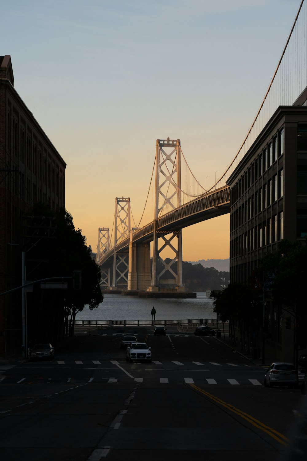 bridge over body of water during sunset