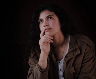 woman in brown jacket with red lipstick