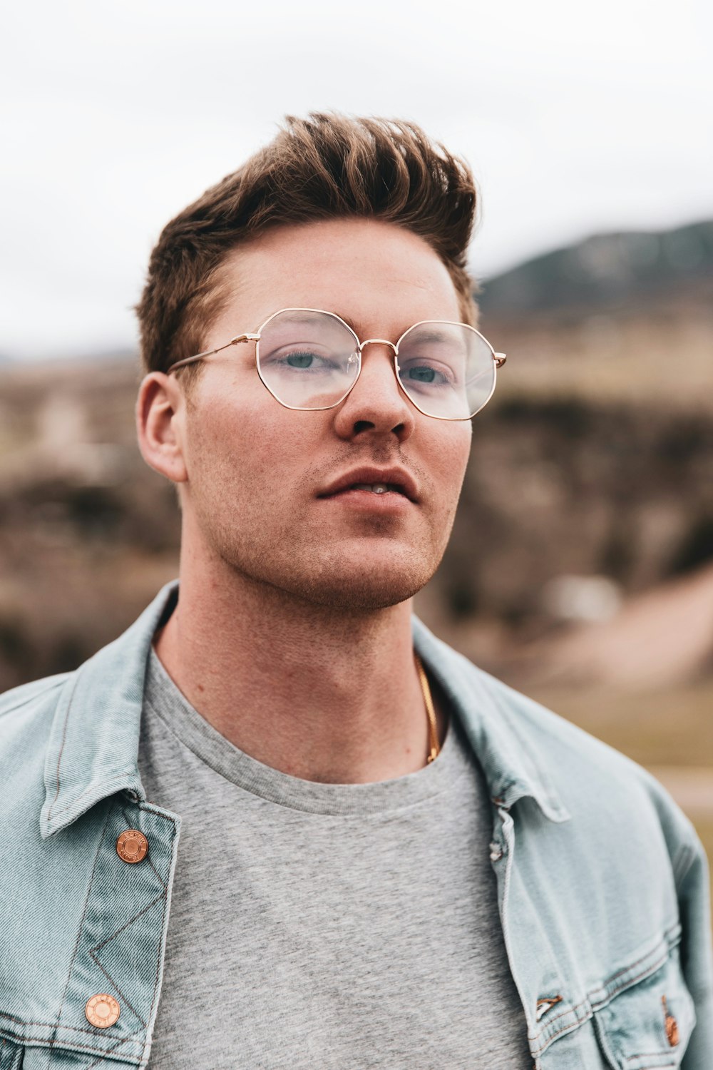 man in grey shirt wearing eyeglasses