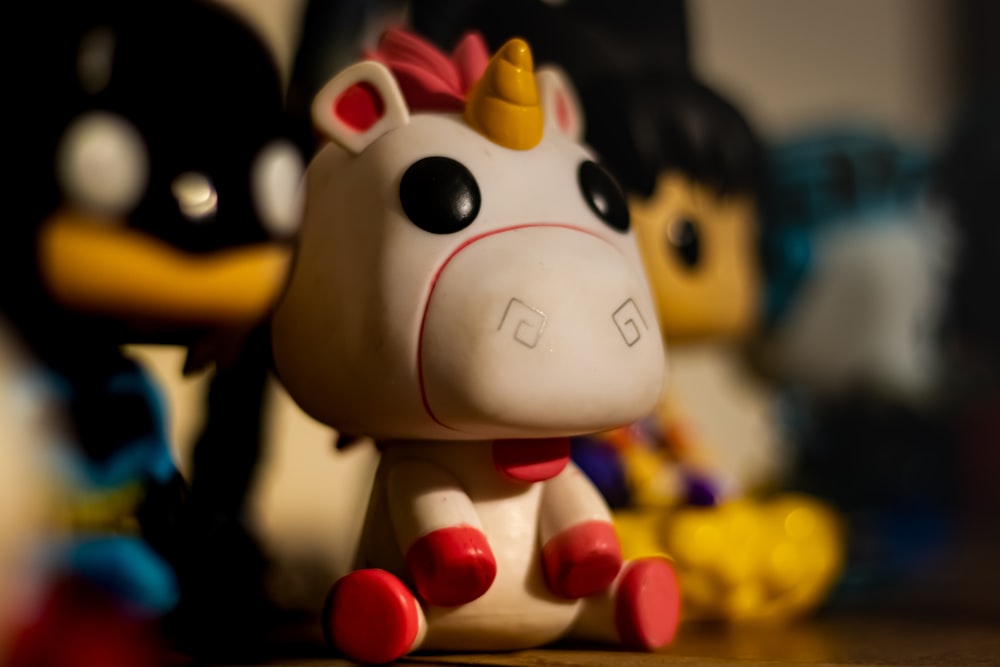 white and black cow plastic toy