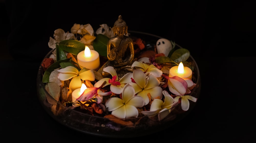 gold buddha figurine on brown round tray