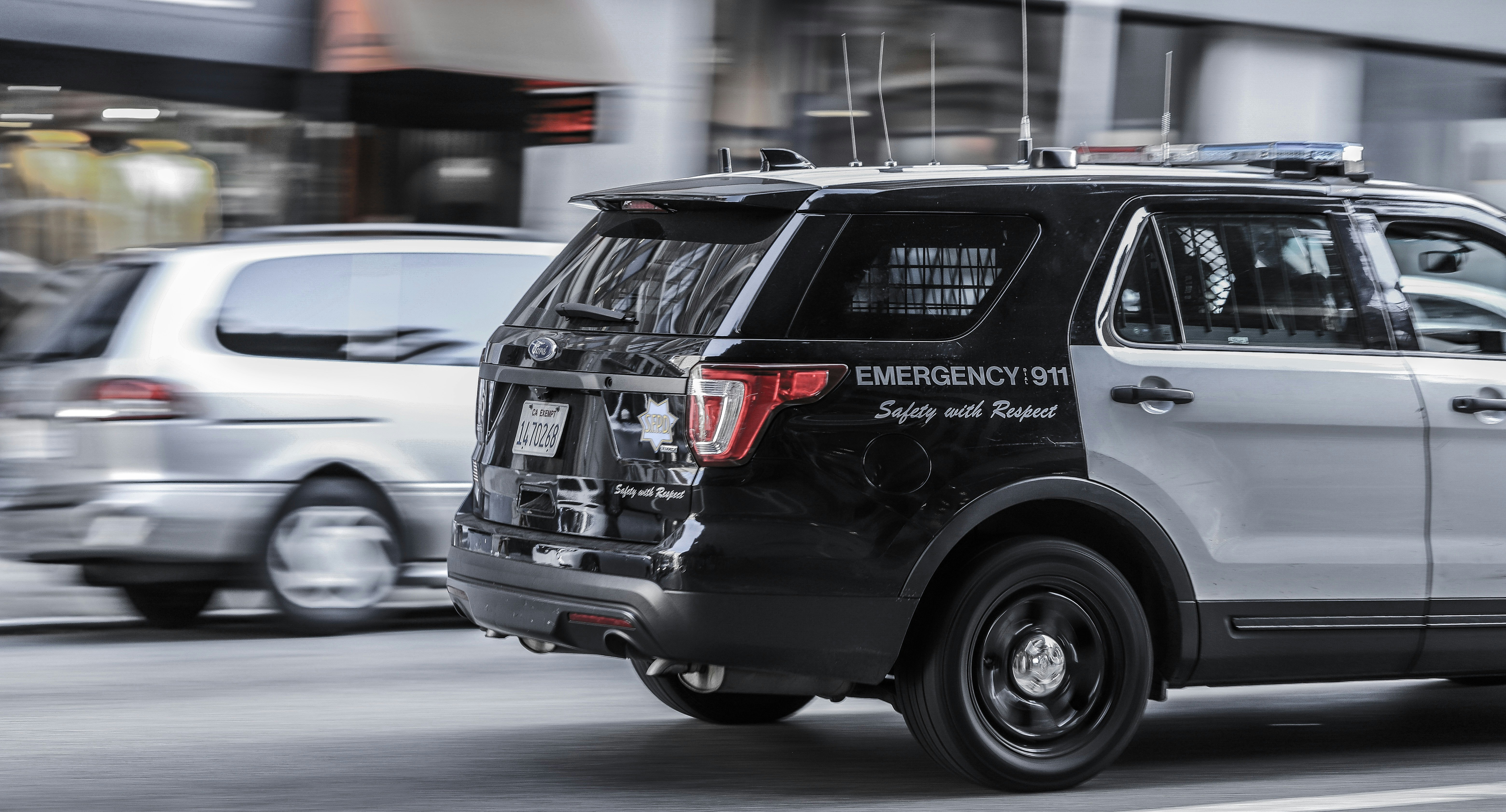 black and white police car on road during daytime