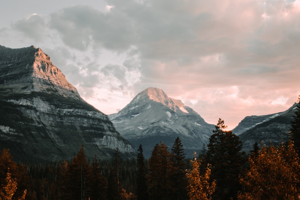 snow covered mountain under cloudy sky during daytime