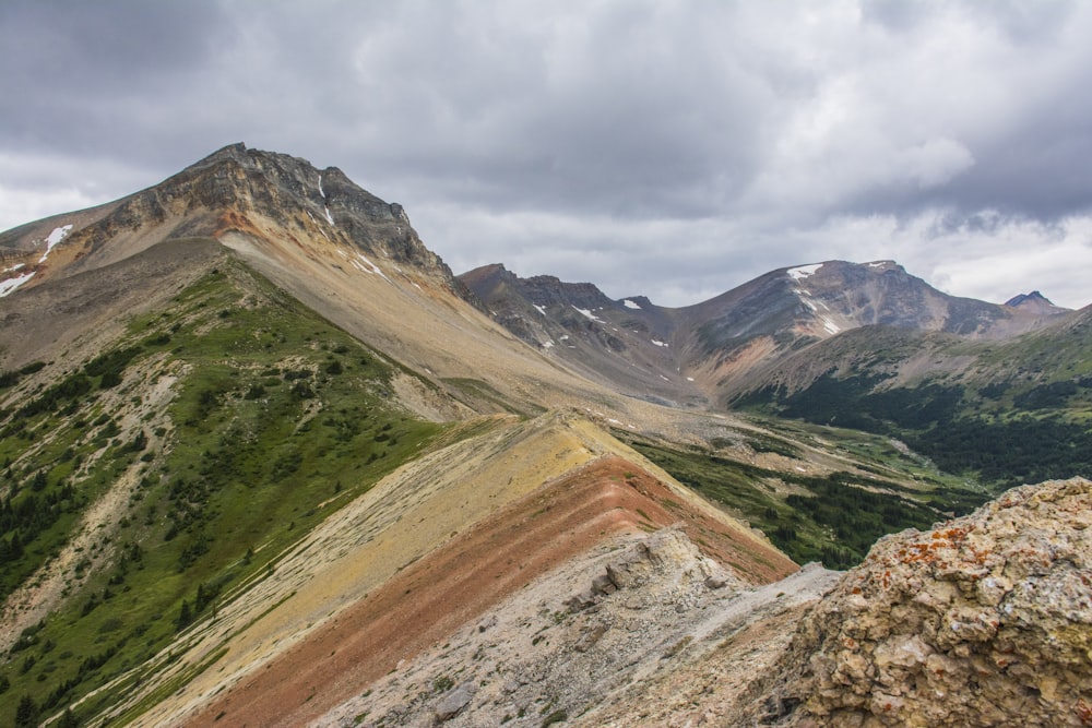 brown and gray mountains under white clouds during daytime