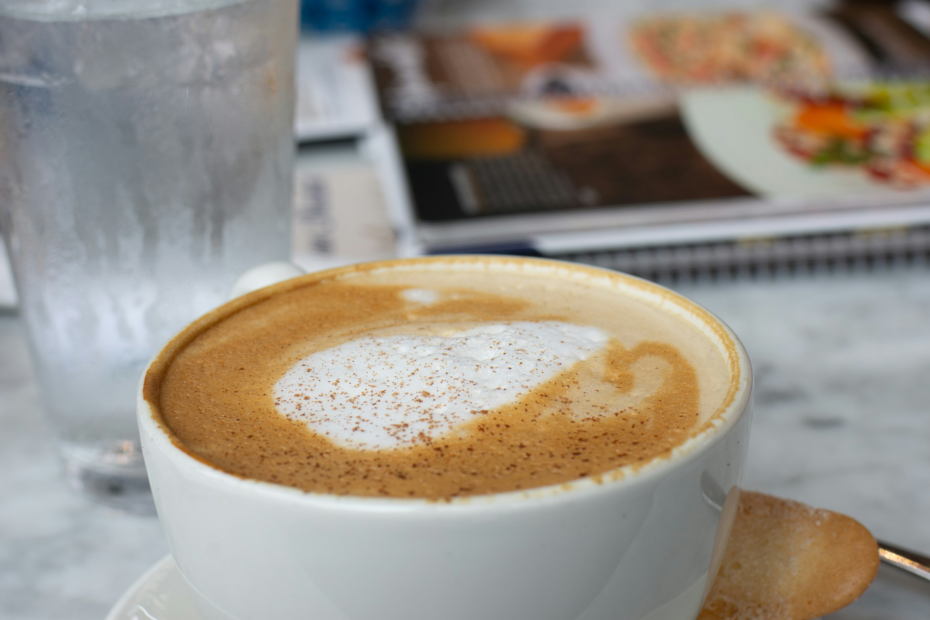 white ceramic cup with brown liquid