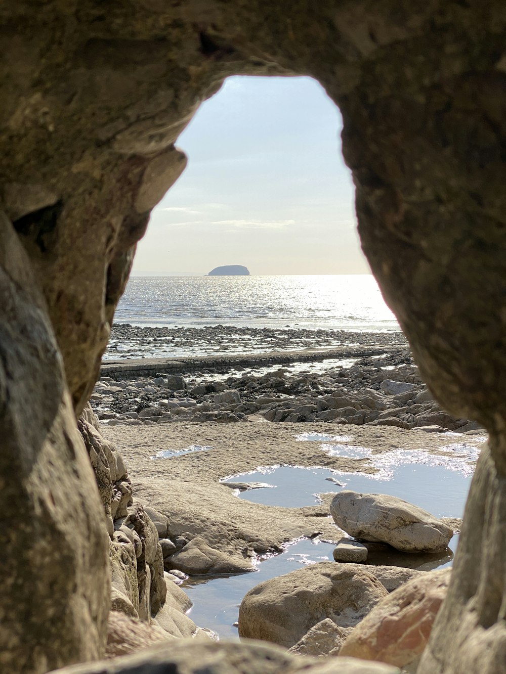 brown rock formation near body of water during daytime