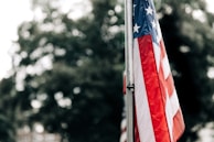 A family proudly displaying their new American flag outside their home.