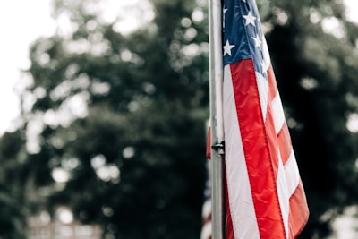 American flag waving outside a construction site symbolizing veteran ownership.