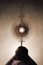 silhouette of person standing near brown round decor