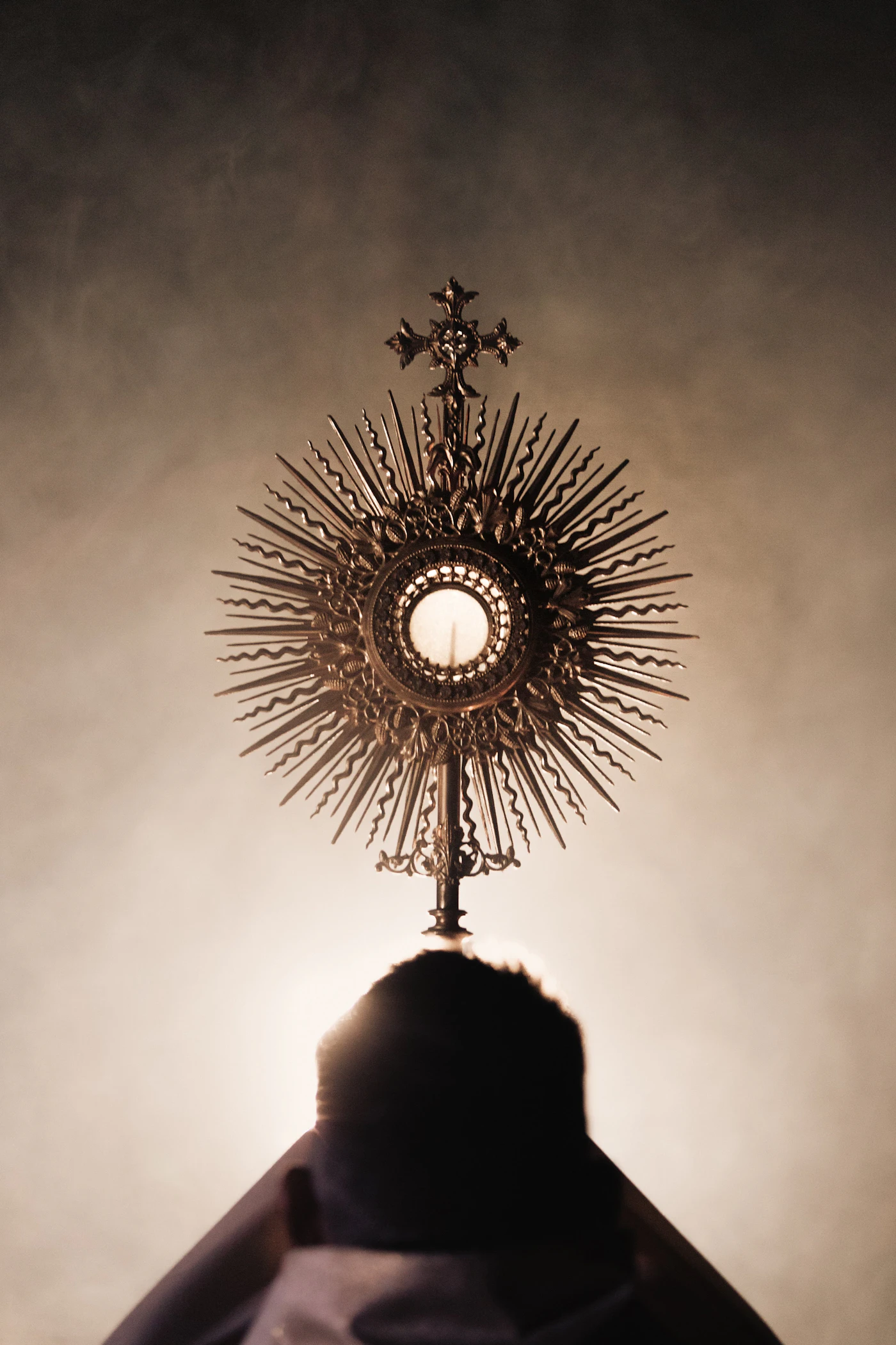 A person kneeling in silent adoration before the exposed Blessed Sacrament