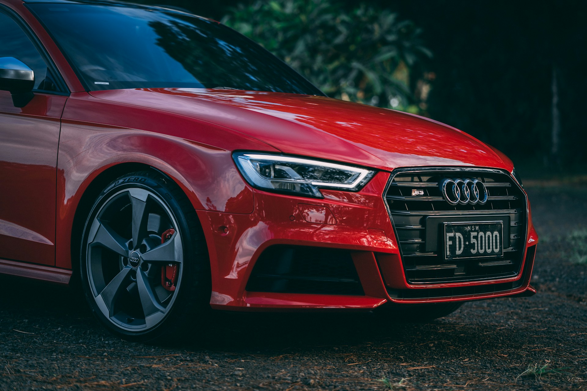 a red car parked on the side of a road