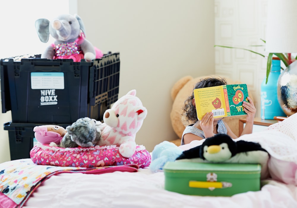 plush toys on pink bed linen