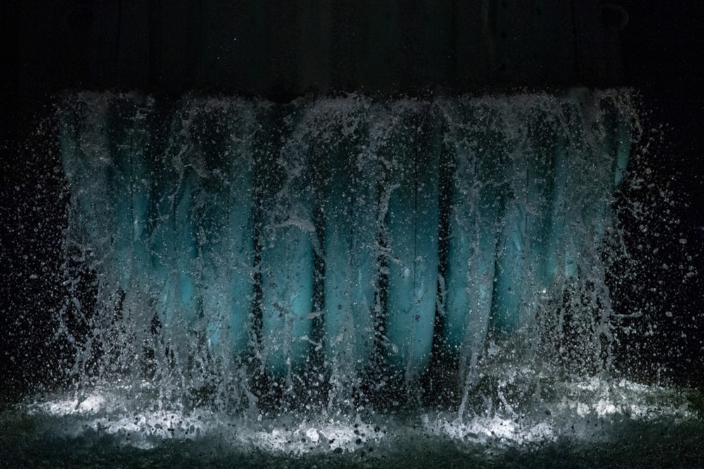 water splash on brown wooden wall