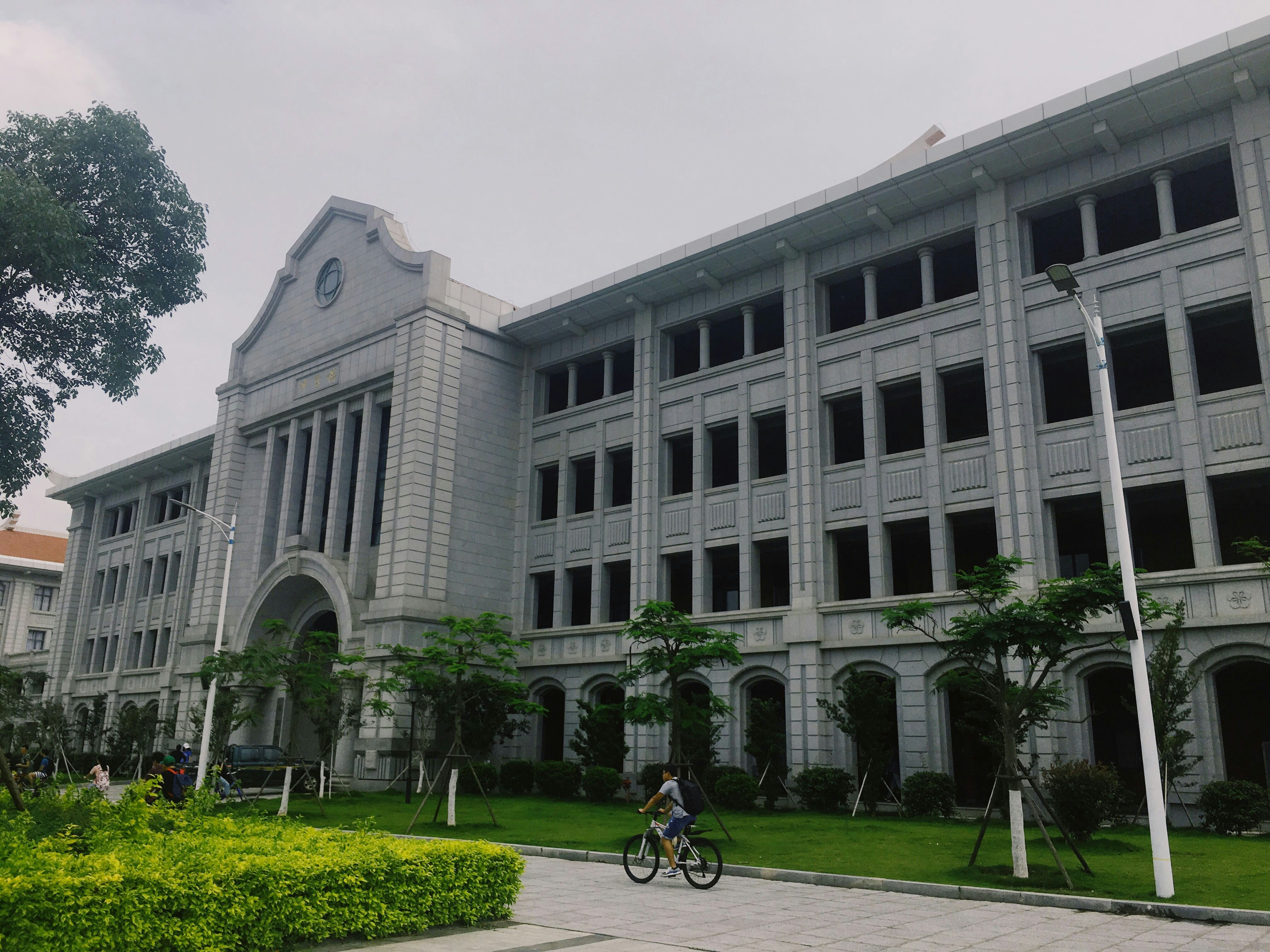 gray concrete building near green grass field during daytime