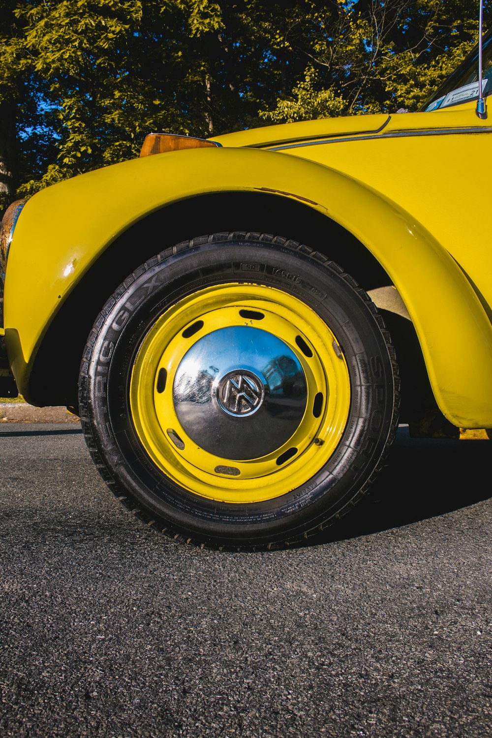 yellow car with gray wheel and tire