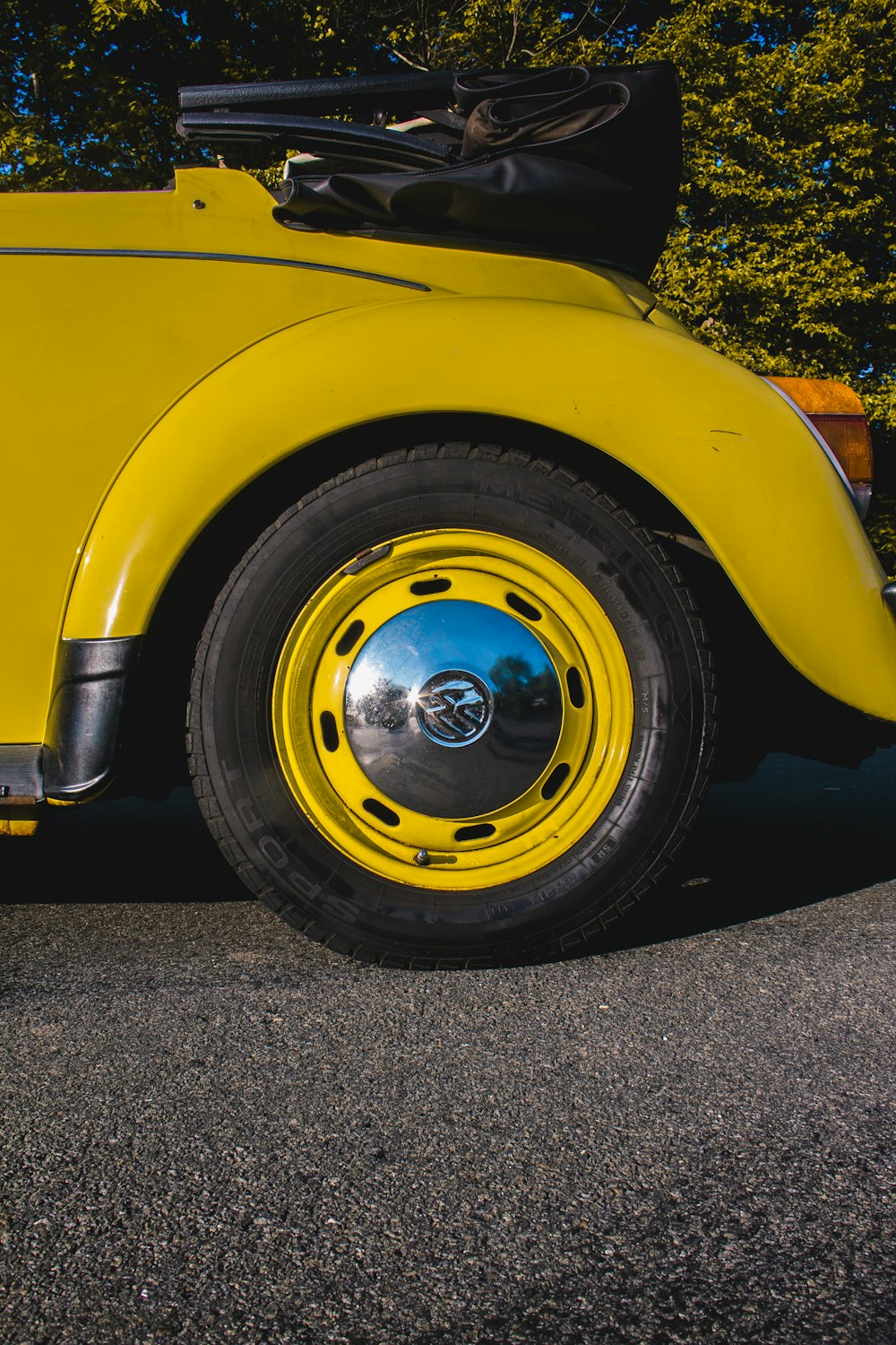 yellow car with gray wheel and tire