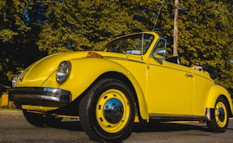 A vibrant blue convertible with its top down, shining after a full vehicle care service.