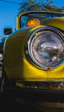 Before and after comparison of a yellowed car headlight transformed to crystal clear condition.