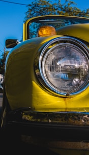 Before and after comparison of a yellowed car headlight transformed to crystal clear condition.