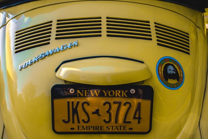 Close view of a vehicle license plate on the rear of a parked car