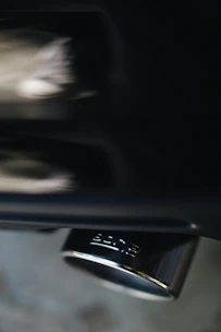 Close-up of a sleek diesel exhaust system with polished metal pipes reflecting light.